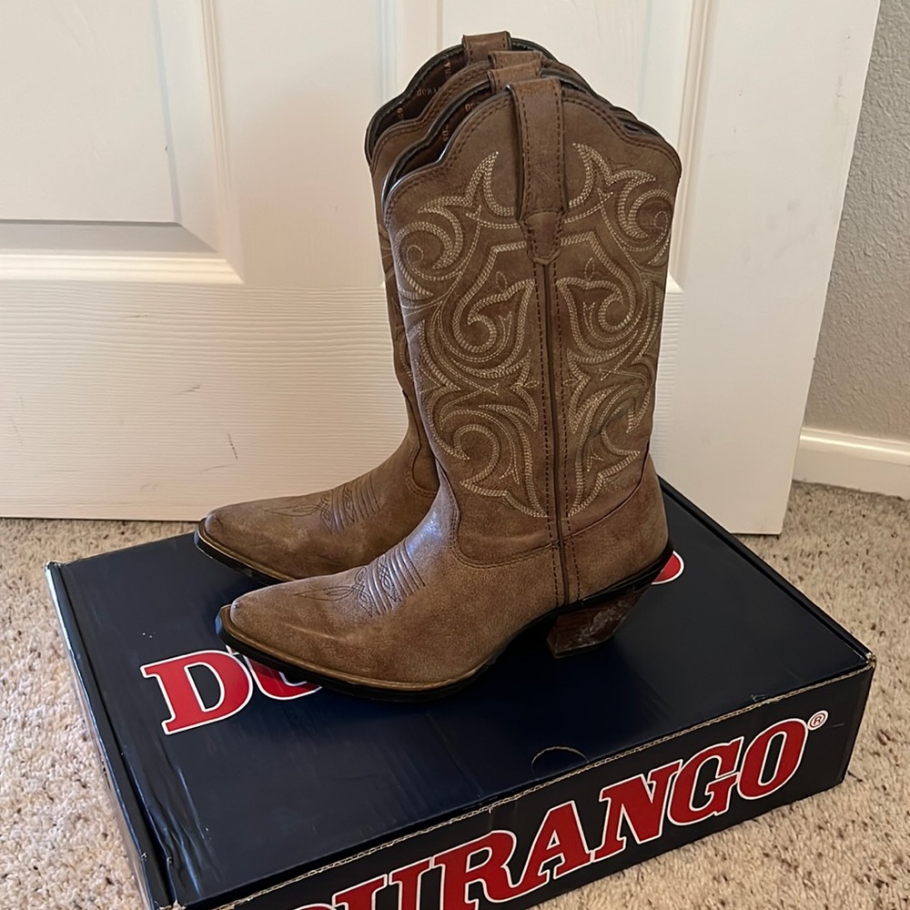 Brown pointed toe cowboy boots.